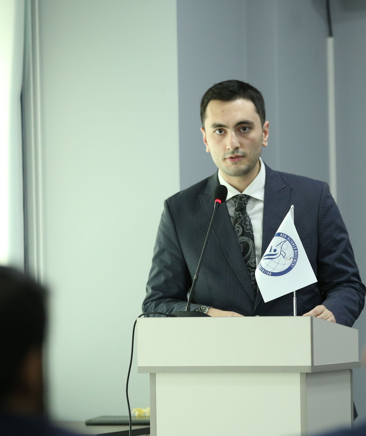 Ordukhan Gahramanzada addressing an audience from a lectern